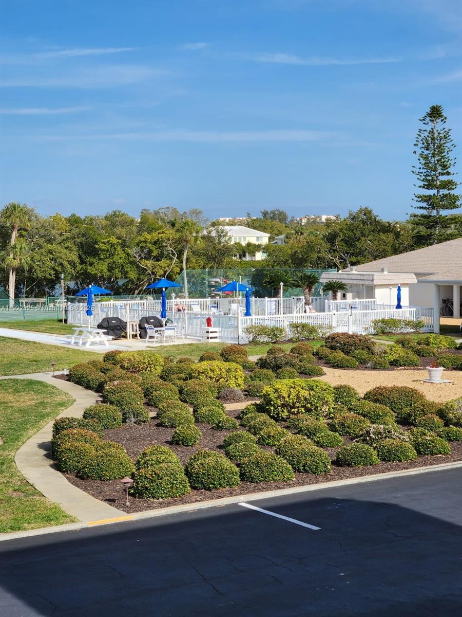 3320 Gulf Of Mexico Drive, Unit 208C Longboat Key, FL 34228 - Photo 38 of 39 a view of a swimming pool with an outdoor seating