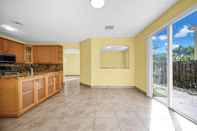 a view of a kitchen with a sink and a refrigerator
