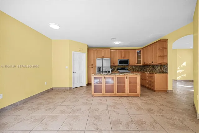 a kitchen with stainless steel appliances granite countertop a stove a sink and a refrigerator