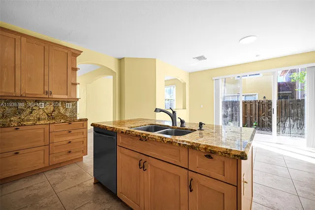 a kitchen with sink window and cabinets