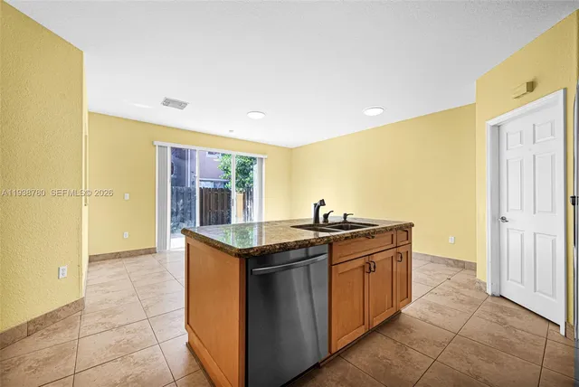 a kitchen with stainless steel appliances granite countertop a sink and cabinets