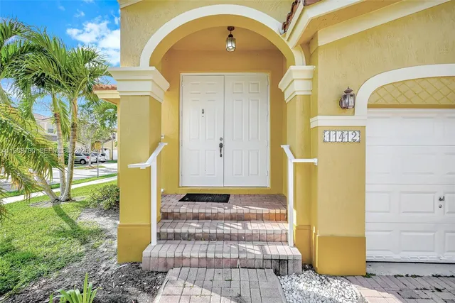a front view of a house with a yard