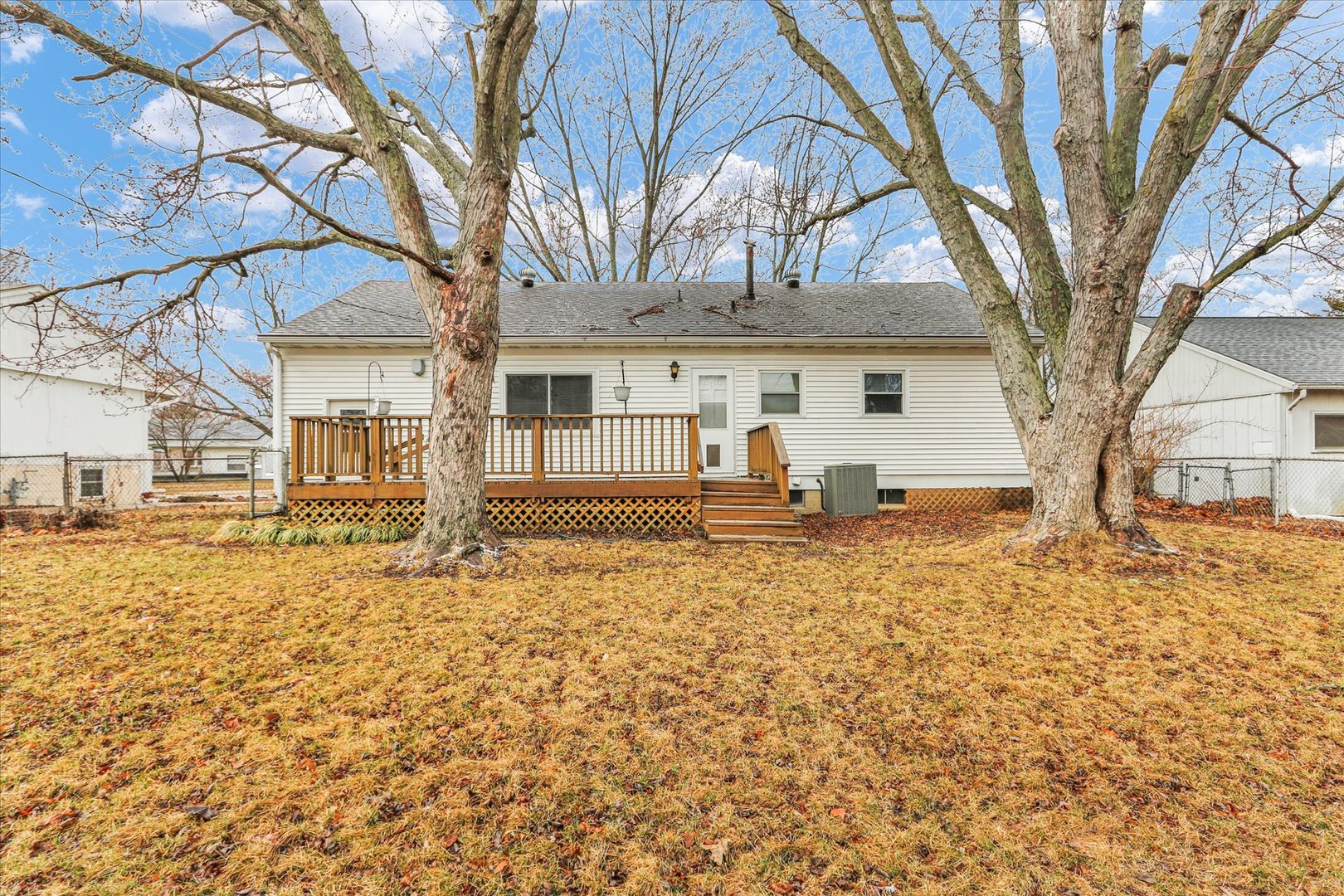 902 Oakcrest Drive Champaign, IL 61821 - Photo 21 of 22 a white house that has a tree in front of it
