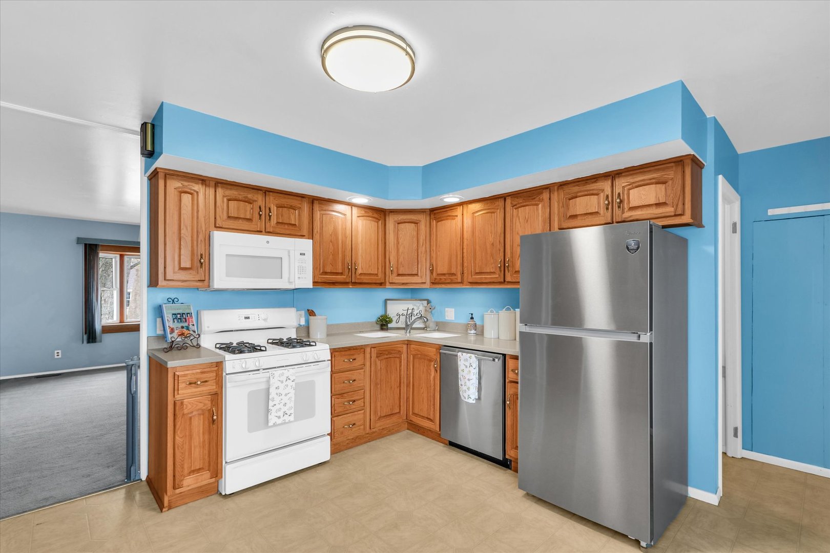 902 Oakcrest Drive Champaign, IL 61821 - Photo 6 of 22 a kitchen with stainless steel appliances granite countertop a refrigerator a sink a stove a microwave oven with white cabinets