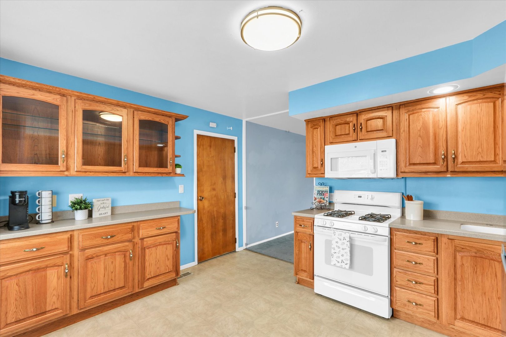 902 Oakcrest Drive Champaign, IL 61821 - Photo 7 of 22 a kitchen with cabinets stainless steel appliances and a window