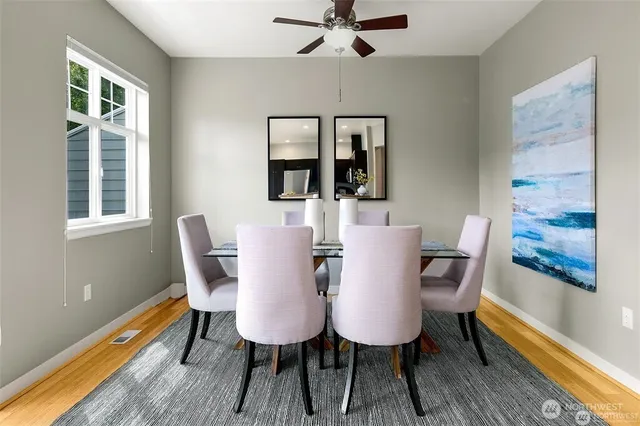 a view of a dining room with furniture window and wooden floor