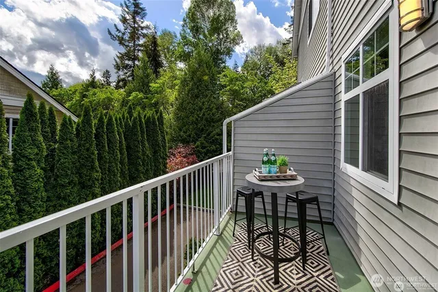 a deck with hardwood table and chairs