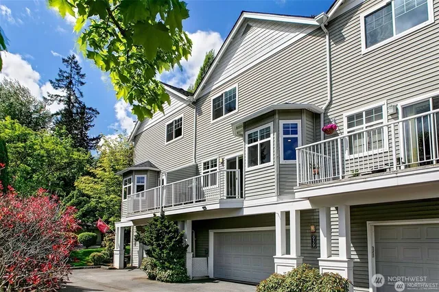 a view of a house with a plants and a tree