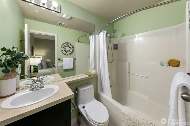a bathroom with a sink mirror toilet and shower