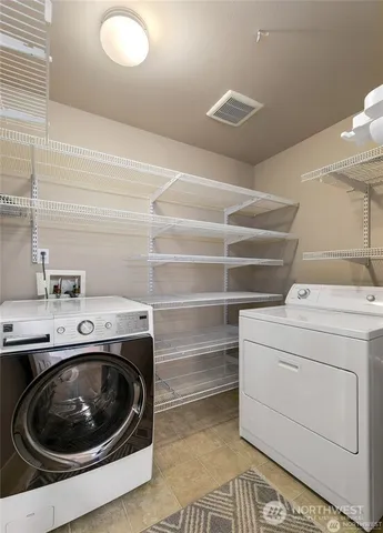 a utility room with sink dryer and washer