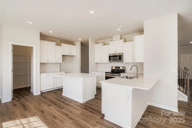 a kitchen with a sink stove and cabinets