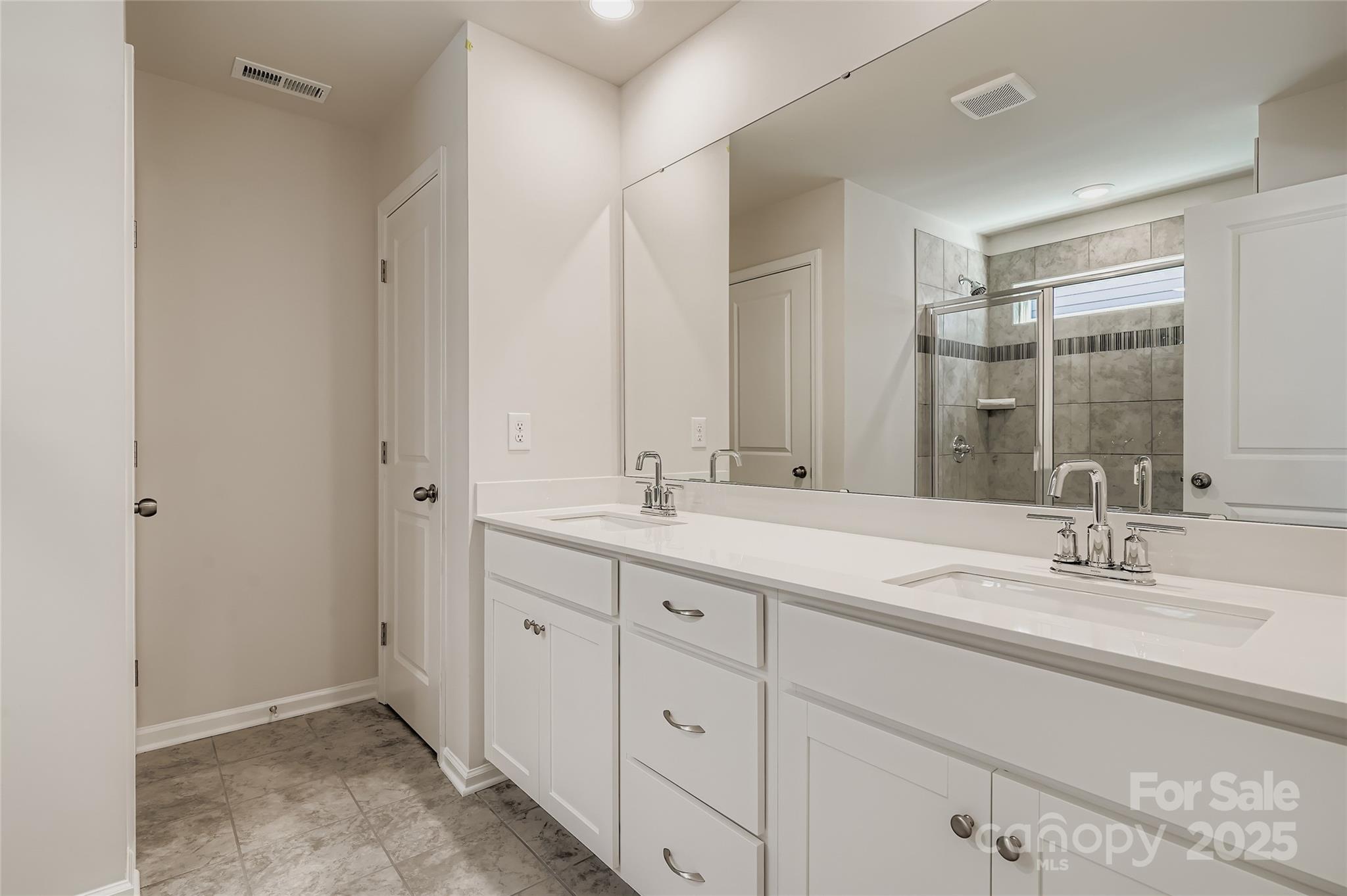 4345 Shimmering Stone Way Maiden, NC 28650 - Photo 7 of 13 a bathroom with a double vanity sink and a mirror