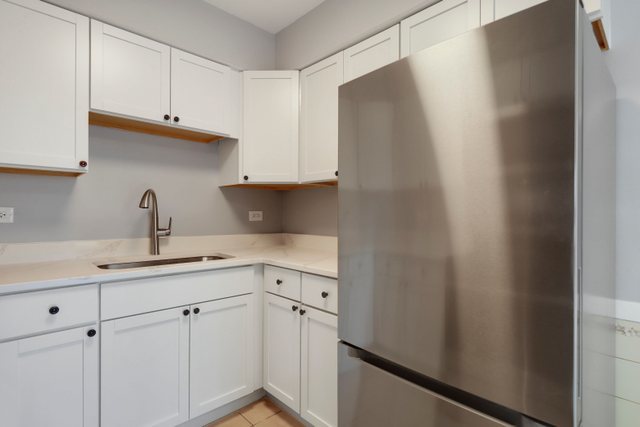 2105 Sutherland Place Hoffman Estates, IL 60169 - Photo 11 of 27 a kitchen with a sink and cabinets