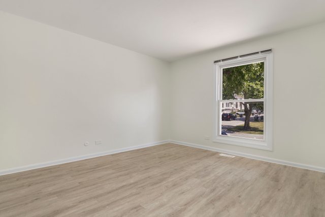 2105 Sutherland Place Hoffman Estates, IL 60169 - Photo 14 of 27 wooden floor in an empty room with a window