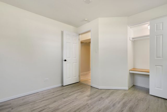 2105 Sutherland Place Hoffman Estates, IL 60169 - Photo 15 of 27 a view of an empty room with wooden floor and a window