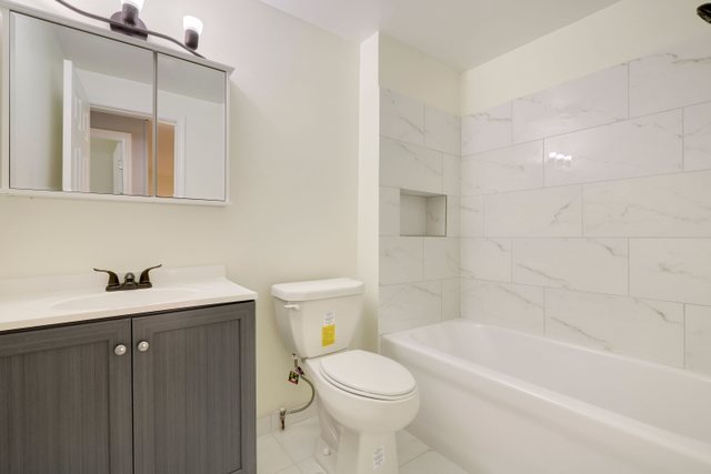 2105 Sutherland Place Hoffman Estates, IL 60169 - Photo 16 of 27 a bathroom with a sink a toilet and bathtub