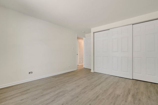2105 Sutherland Place Hoffman Estates, IL 60169 - Photo 18 of 27 a view of an empty room with wooden floor
