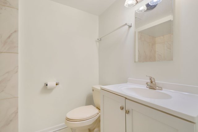 2105 Sutherland Place Hoffman Estates, IL 60169 - Photo 20 of 27 a bathroom with a sink toilet and vanity