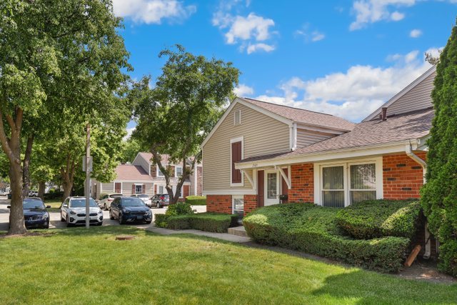 2105 Sutherland Place Hoffman Estates, IL 60169 - Photo 2 of 27 a front view of a house with a garden and plants