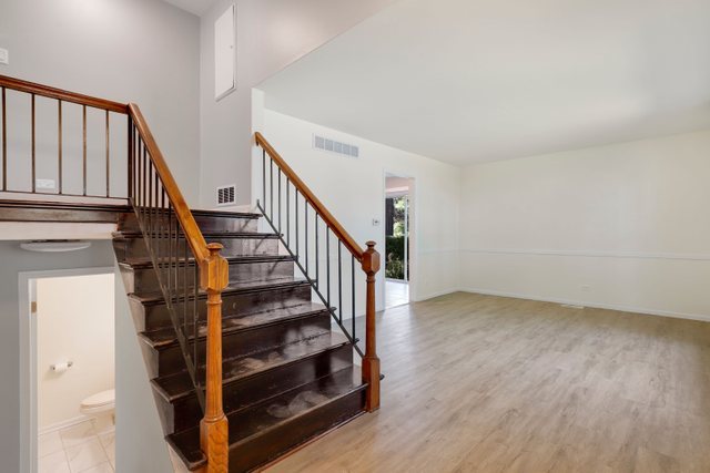 2105 Sutherland Place Hoffman Estates, IL 60169 - Photo 5 of 27 a view of staircase with wooden floor and white walls