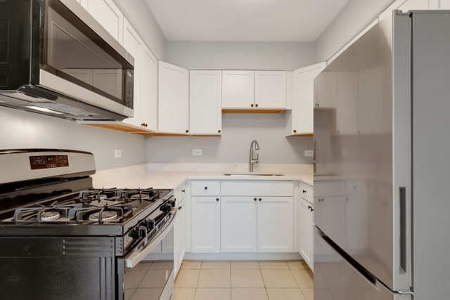 2105 Sutherland Place Hoffman Estates, IL 60169 - Photo 9 of 27 a kitchen with a stove sink and cabinets