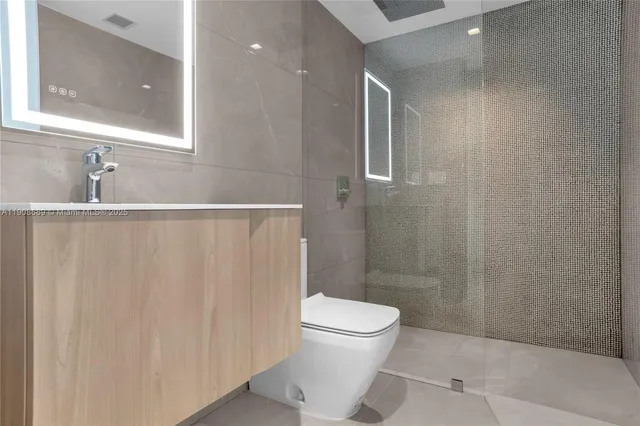 a view of a hallway with wooden floor and a potted plant