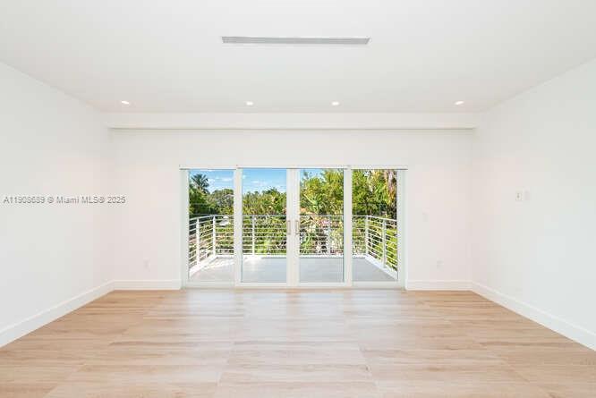 1325 Bay Drive Miami Beach, FL 33141 - Photo 23 of 49 a view of an empty room with wooden floor and a window