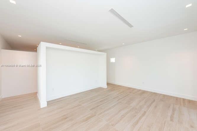 1325 Bay Drive Miami Beach, FL 33141 - Photo 24 of 49 an empty room with wooden floor and windows