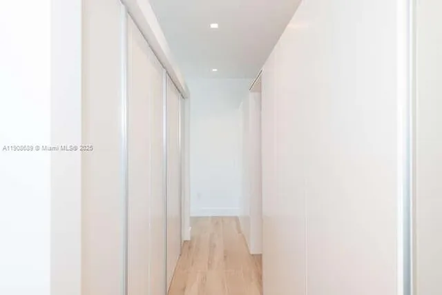 a view of roof deck with couches and sky view