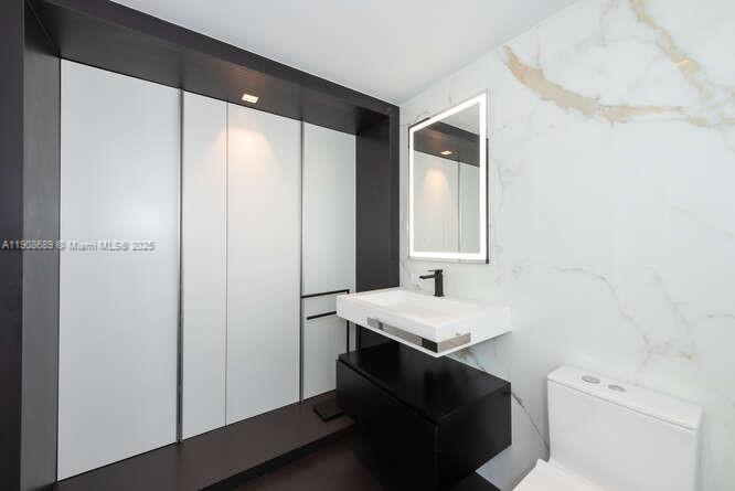 1325 Bay Drive Miami Beach, FL 33141 - Photo 44 of 49 a bathroom with a sink a toilet and vanity