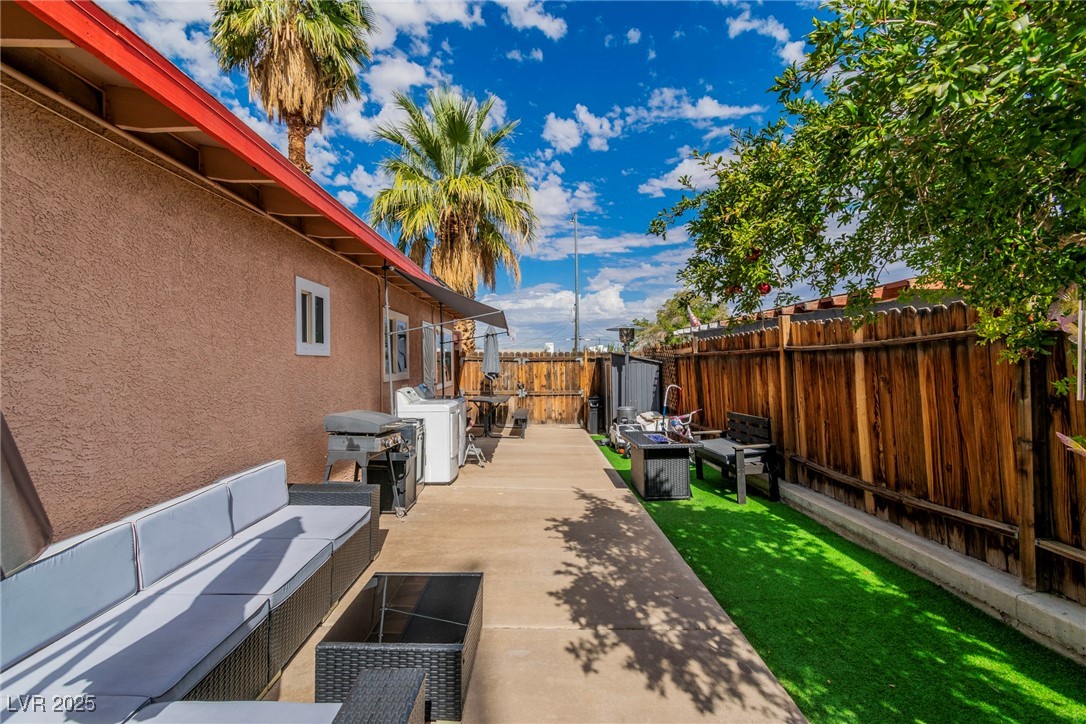 111 Maple Street Henderson, NV 89015 - Photo 34 of 37 Fenced backyard with an outdoor living space, a patio area, and a grill