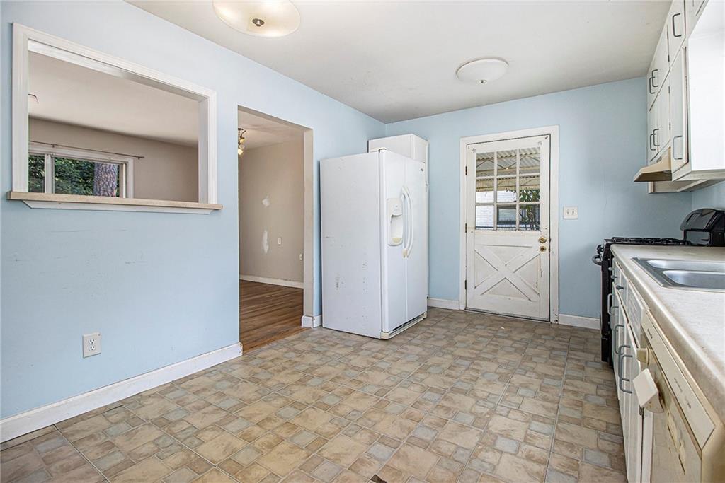 1961 Kenwood Road Southeast Smyrna, GA 30082 - Photo 11 of 33 an empty room with windows and wardrobe