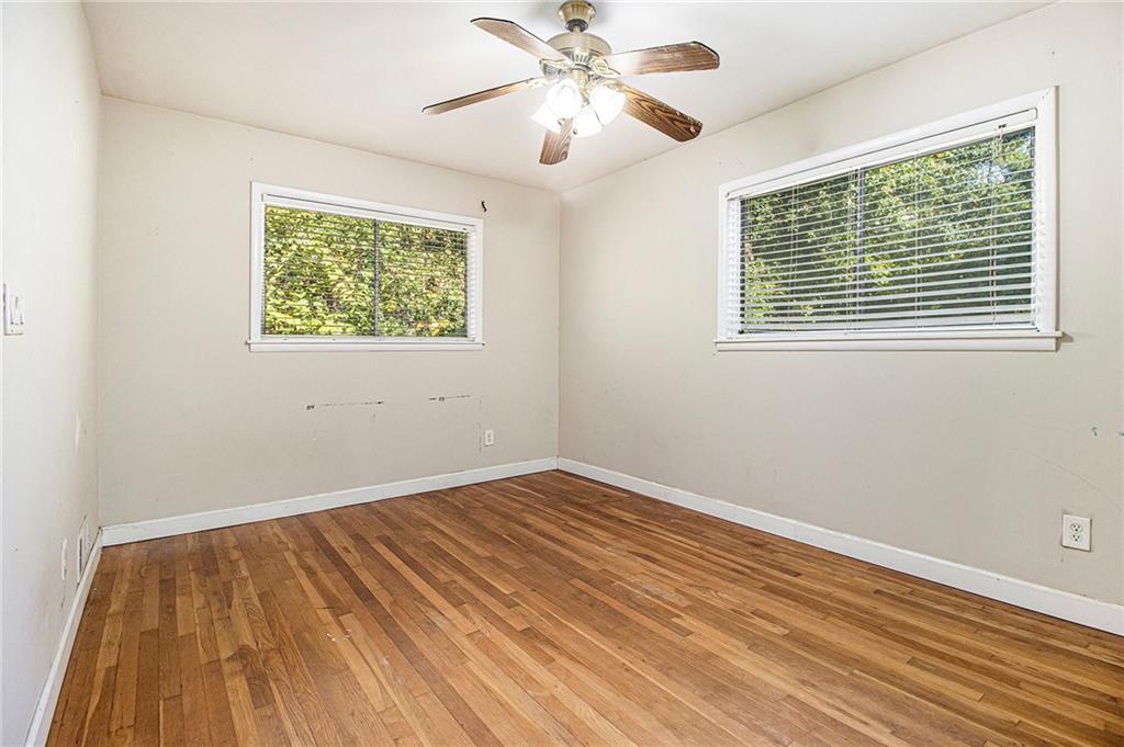 1961 Kenwood Road Southeast Smyrna, GA 30082 - Photo 12 of 33 a view of an empty room with wooden floor and a window