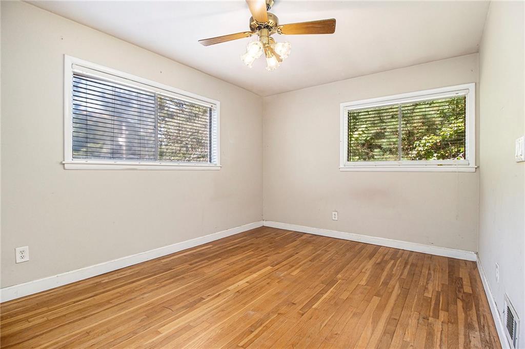 1961 Kenwood Road Southeast Smyrna, GA 30082 - Photo 15 of 33 a view of an empty room with a window and wooden floor