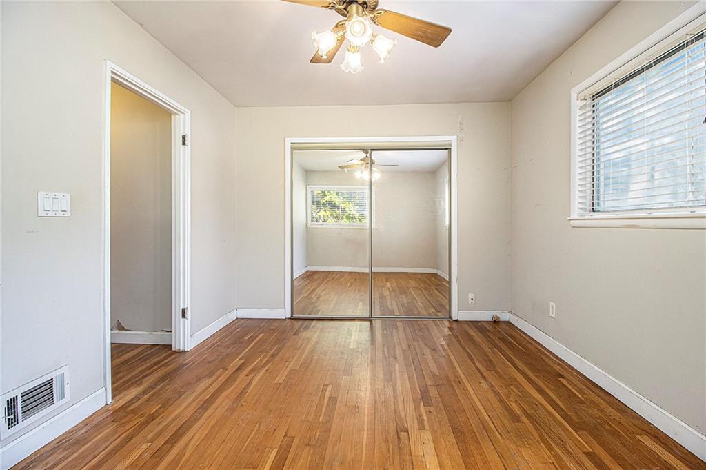 1961 Kenwood Road Southeast Smyrna, GA 30082 - Photo 17 of 33 wooden floor in an empty room with a window