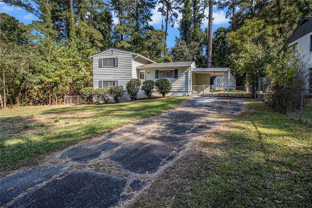 1961 Kenwood Road Southeast Smyrna, GA 30082 - Photo 2 of 33 a front view of a house with a yard and trees