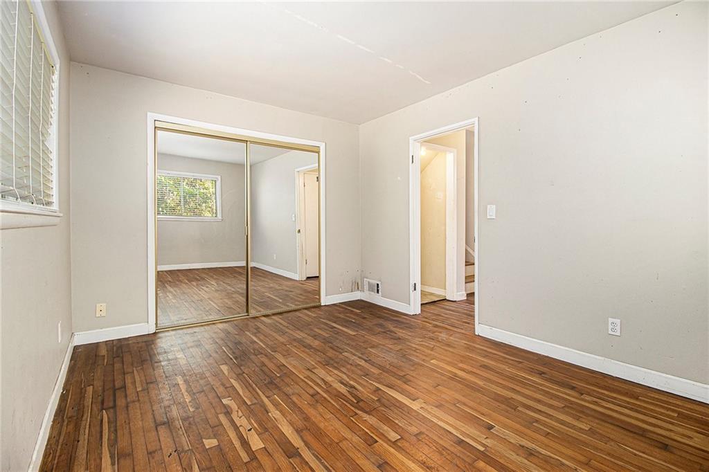 1961 Kenwood Road Southeast Smyrna, GA 30082 - Photo 21 of 33 an empty room with wooden floor and windows