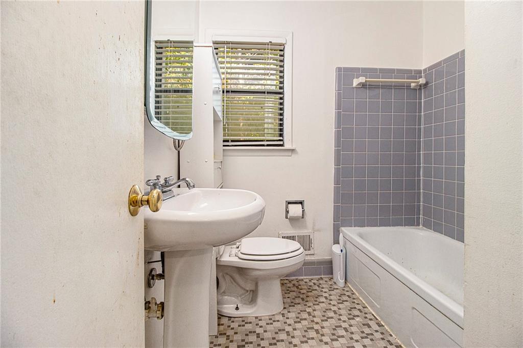 1961 Kenwood Road Southeast Smyrna, GA 30082 - Photo 22 of 33 a bathroom with a sink toilet and shower