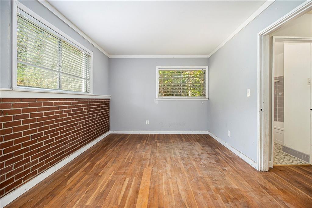 1961 Kenwood Road Southeast Smyrna, GA 30082 - Photo 23 of 33 a view of an empty room with wooden floor and a window
