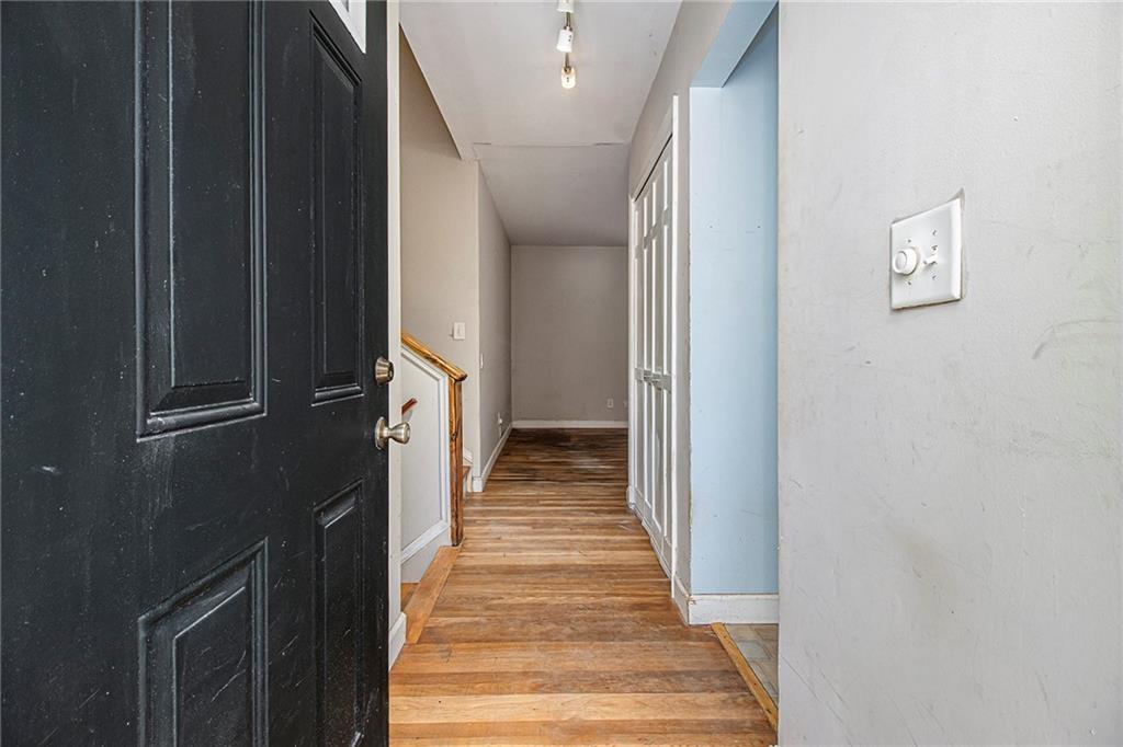 1961 Kenwood Road Southeast Smyrna, GA 30082 - Photo 5 of 33 a view of a hallway with wooden floor and staircase