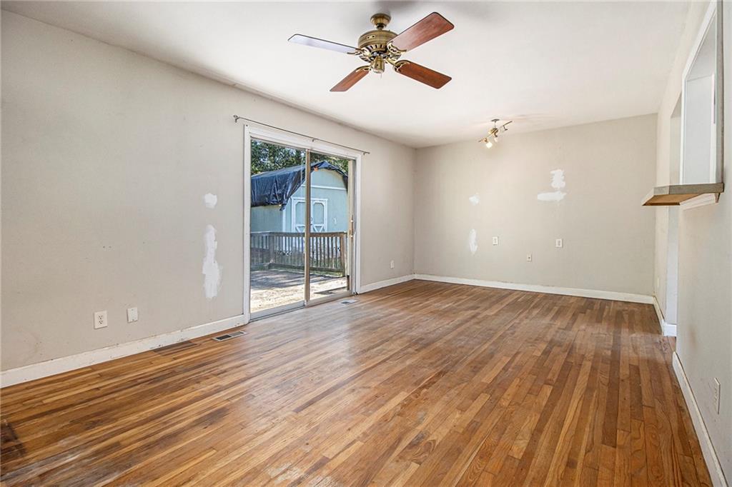 1961 Kenwood Road Southeast Smyrna, GA 30082 - Photo 6 of 33 wooden floor in an empty room with a window