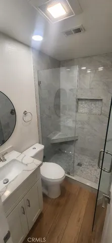 a bathroom with a sink toilet and mirror