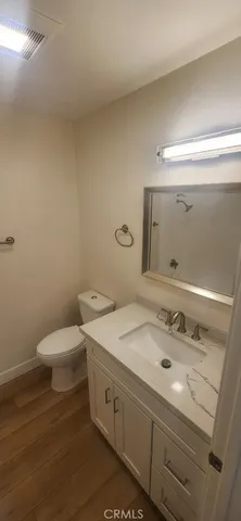 wooden floor in an empty room with a mirror