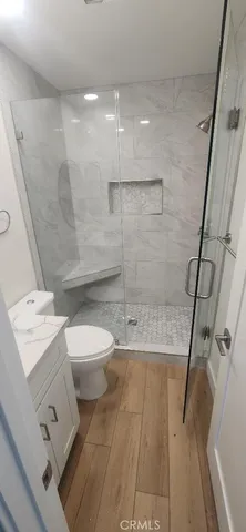 a view of a kitchen with a sink and a refrigerator