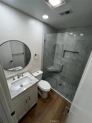 a bathroom with a sink toilet and shower