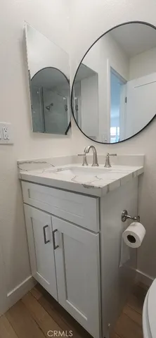 a view of walk in closet with wooden floor