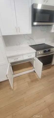 a kitchen with stainless steel appliances a refrigerator and a stove