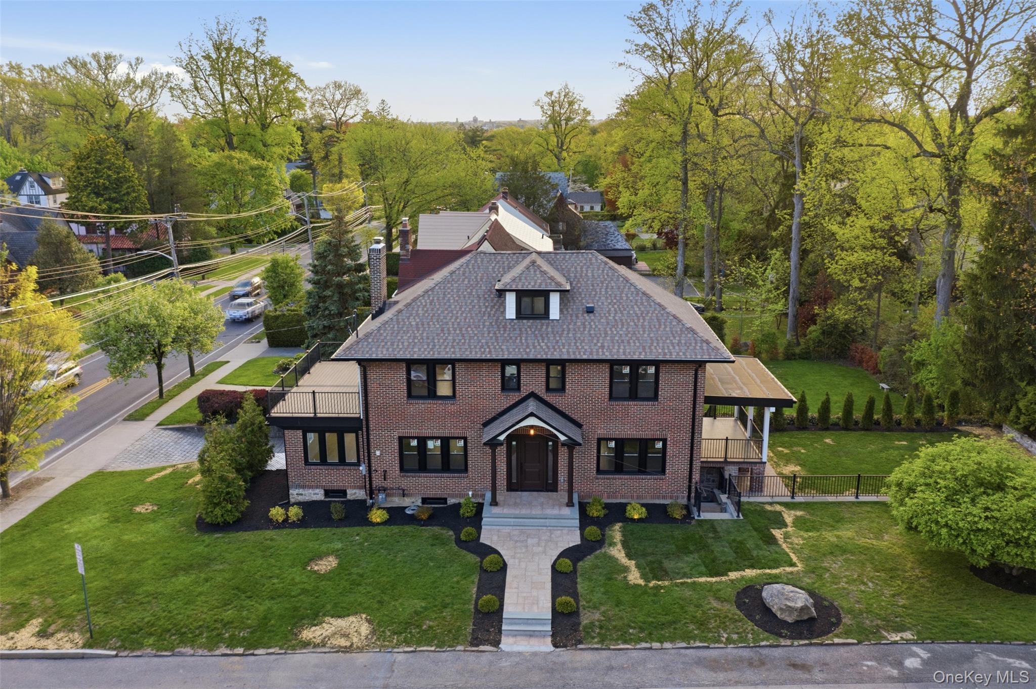 40 Calhoun Avenue New Rochelle, NY 10801 - Photo 42 of 49 Brick exterior with black-framed windows and a gabled roof