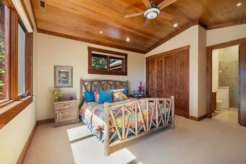 a bedroom with bed and wooden floor