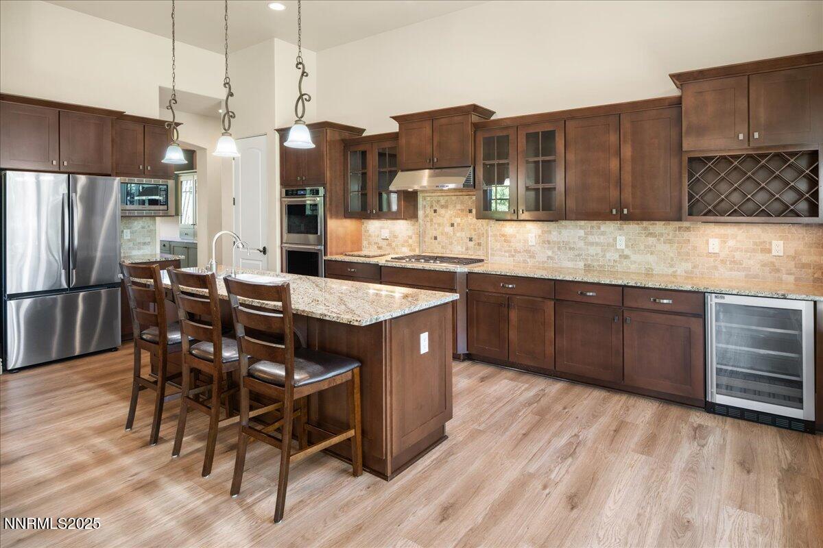3880 Boulder Patch Reno, NV 89511 - Photo 14 of 53 a kitchen with stainless steel appliances granite countertop a table chairs sink refrigerator and microwave